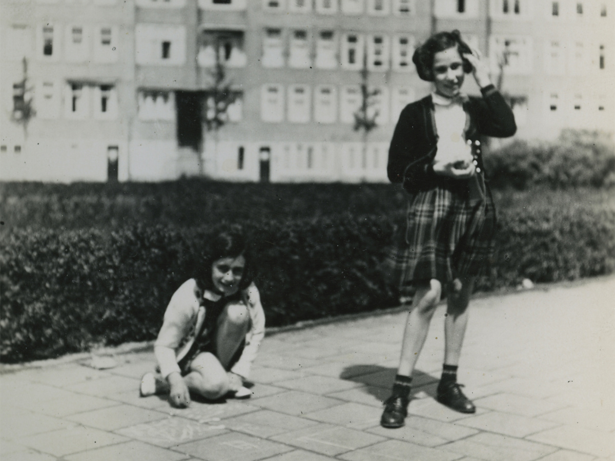 Anne Frank, left, and her friend Hannah Goslar playing at the Merwedeplein in Amsterdam, May 1940. 