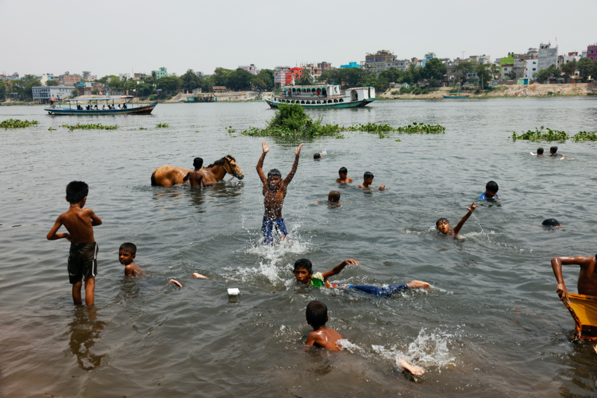 Children bathe at the Buriganga river during a countrywide heat wave in Dhaka, Bangladesh, on 6th June, 2023