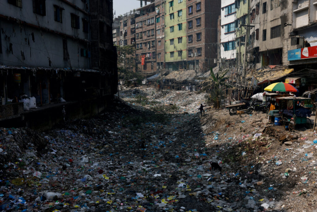 Plastics and other waste blocks the flow of water from nearby canals that are connected to the Buriganga river in Dhaka, Bangladesh, on 6th March, 2023.