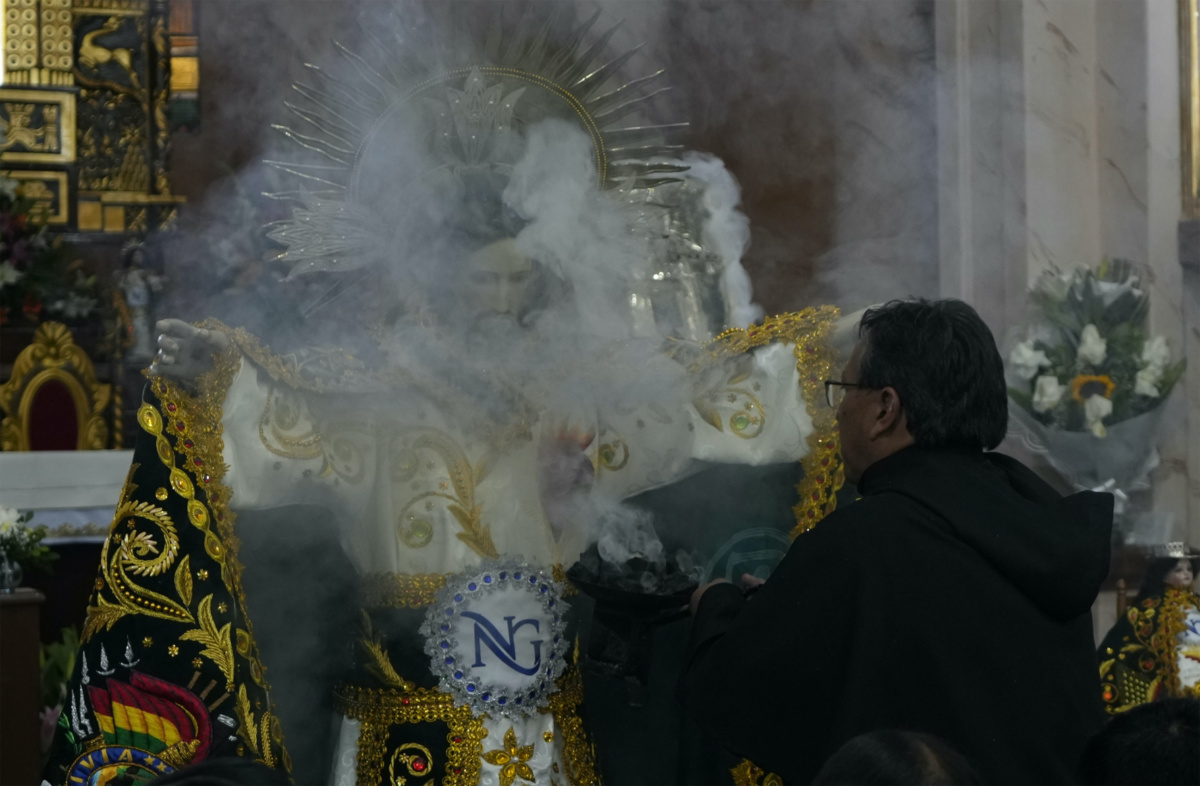 A priest releases incense after dressing the statue of "Jesus del Gran Poder" or Lord of Great Power, at the "Jesus del Gran Poder" church in La Paz, Bolivia, on Thursday, 1st June, 2023