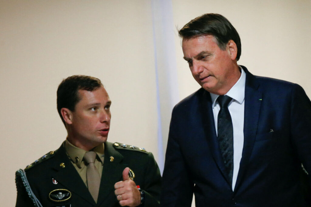 Brazil's President Jair Bolsonaro talks with army major, Mauro Cid after a meeting at the Planalto Palace in Brasilia, Brazil, on 18th June, 2019.
