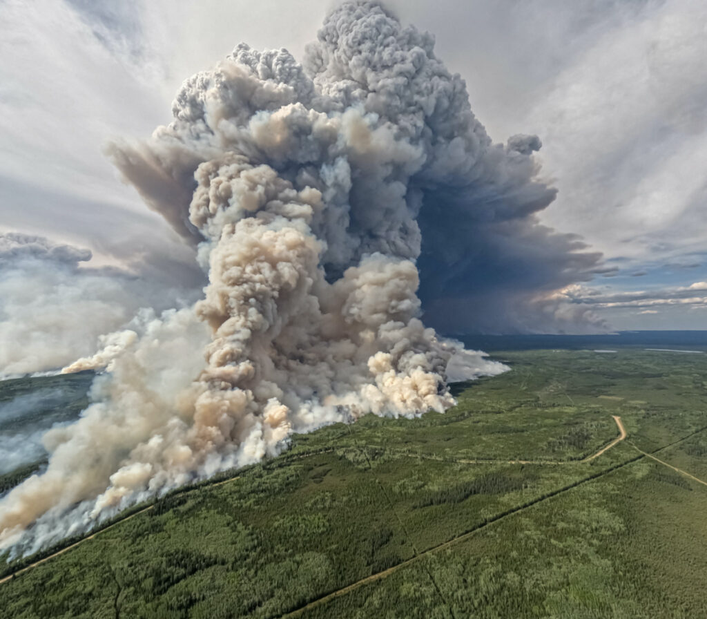 Smoke billows upwards from a planned ignition by firefighters tackling the Donnie Creek Complex wildfire south of Fort Nelson, British Columbia, Canada, on 3rd June, 2023.