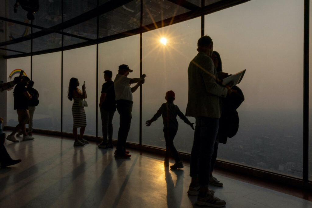 People take photographs as a smokey Toronto is seen from the CN Tower as wildfires in Ontario and Quebec continue to burn, in Toronto, Ontario, Canada on 6th June, 2023.