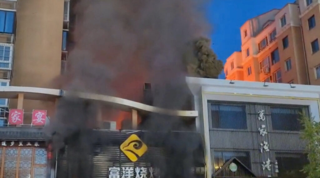Smoke rises from a building following a gas explosion at a barbecue restaurant in Yinchuan city, Ningxia, China, on 21st June, 2023 in this screengrab obtained from a handout video.