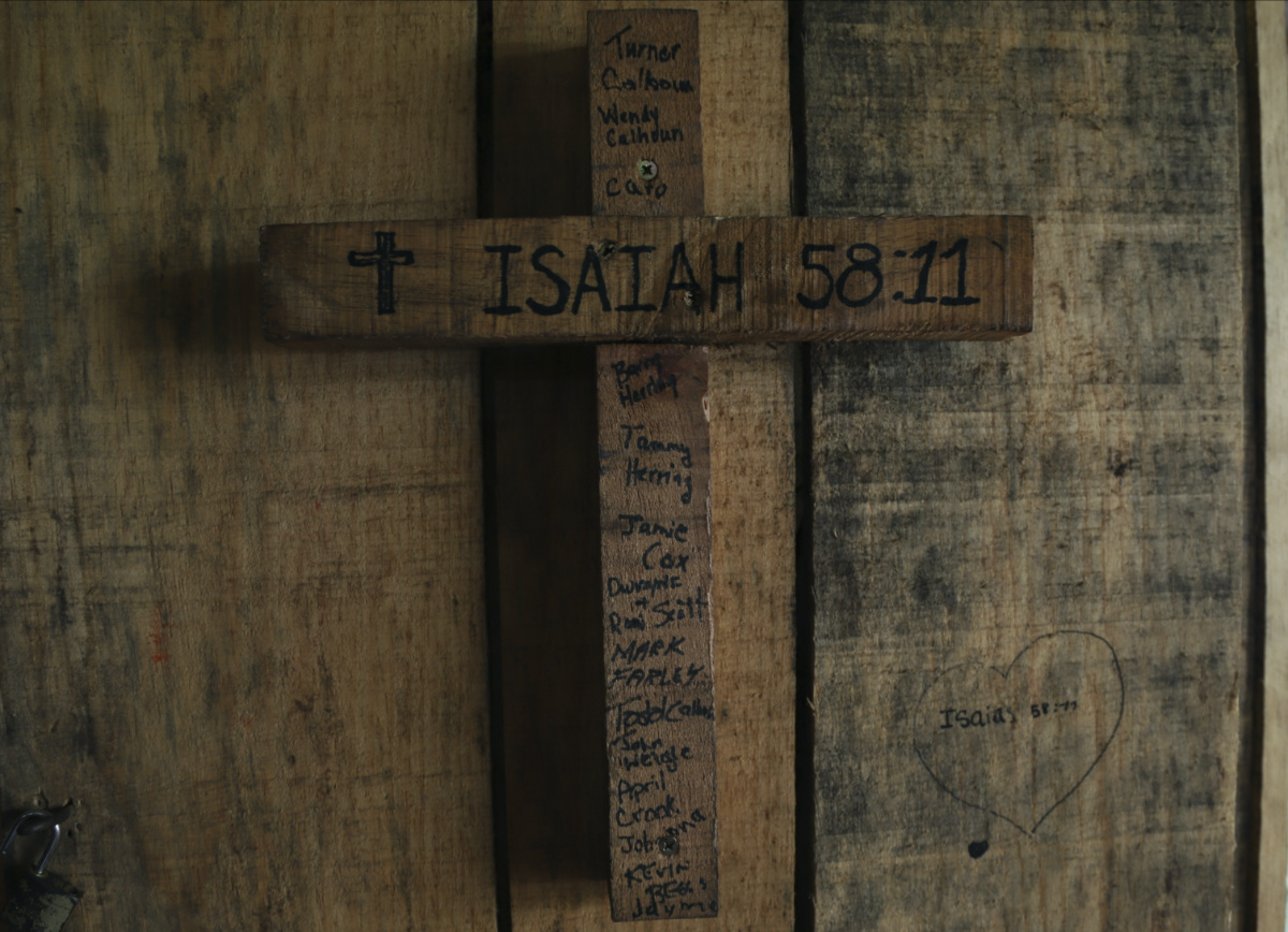 A cross is engraved with a biblical verse and the name of US church members who built the house where the cross hangs, in an area once controlled by gangs, in Santa Ana, El Salvador, on Saturday, 29th April, 2023. 