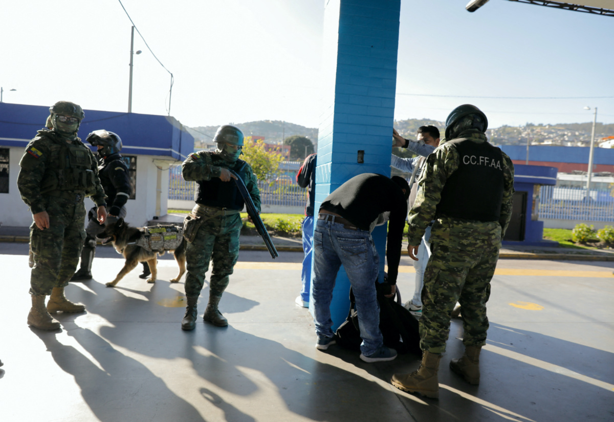 Members of the Armed Forces check people for guns, munitions and explosives during a stop and frisk operation at a bus terminal, in Quito, Ecuador on 4th May, 2023