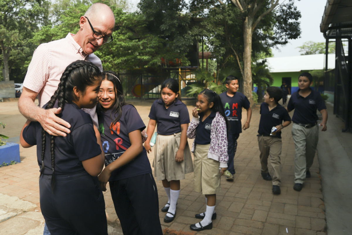 Pastor Kenton Moody, left, is greeted by Salvadoran children at the Hosanna School, an institution run by the Assemblies of God Church, in an area once controlled by gangs, in Santa Ana, El Salvador, Wednesday, on 3rd May, 2023.