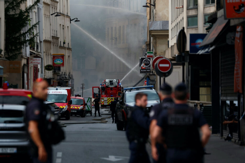 French police secure the area as firefighters work after several buildings on fire following a gas explosion in the fifth arrondissement of Paris, France, on 21st June, 2023.