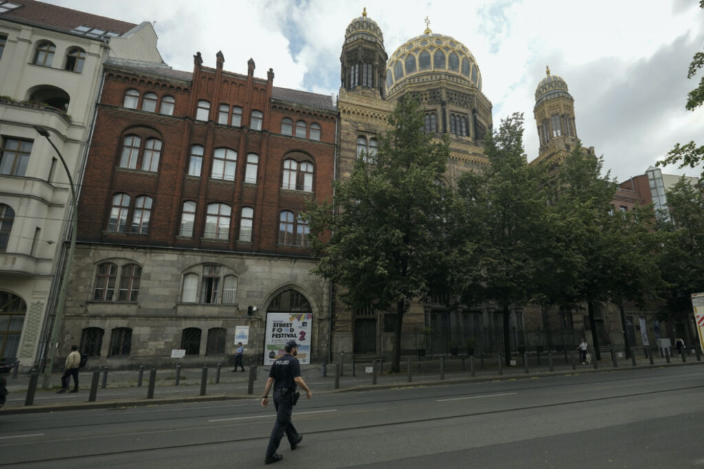 A police officer patrols in front of the 'New Synagogue' in central Berlin, Germany, on Tuesday, 27th June, 2023.