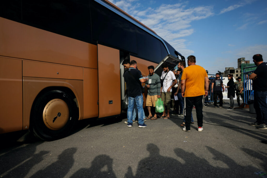 Migrants, survivors of a deadly shipwreck after a boat capsized at open sea off Greece, board a bus as they are being transferred to Athens from the port of Kalamata, Greece, on 16th June, 2023.