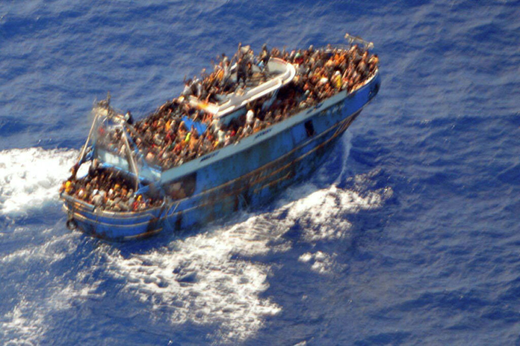 A undated handout photo provided by the Hellenic Coast Guard shows migrants onboard a boat during a rescue operation, before their boat capsized on the open sea, off Greece, on 14th June, 2023.