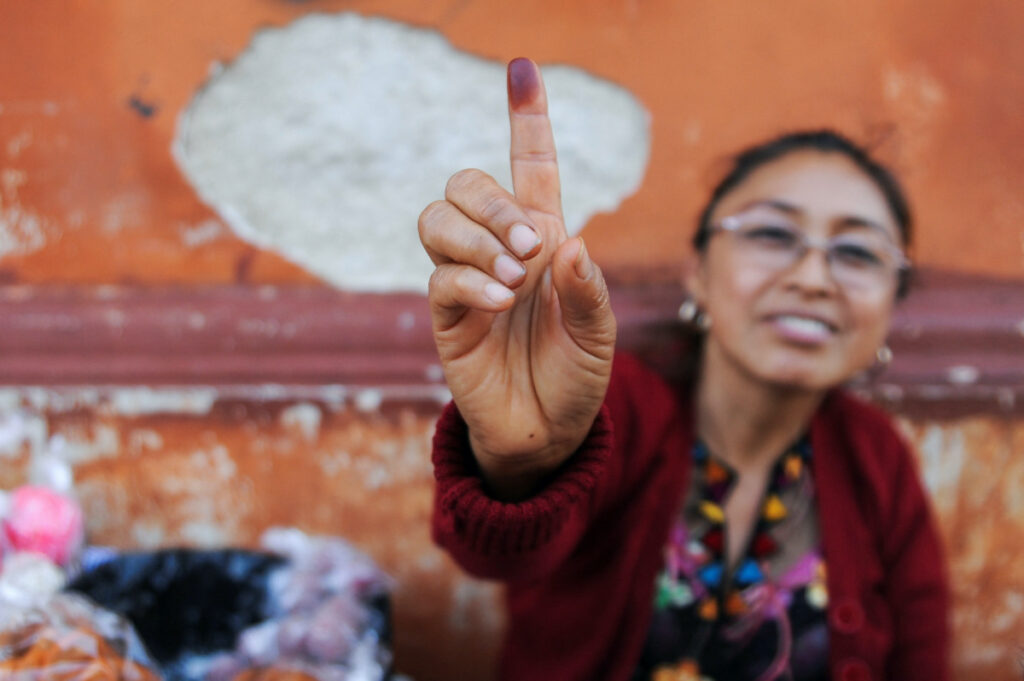 A woman shows her ink-stained finger during the first round of Guatemala's presidential election in Guatemala City, Guatemala, on 25th June, 2023