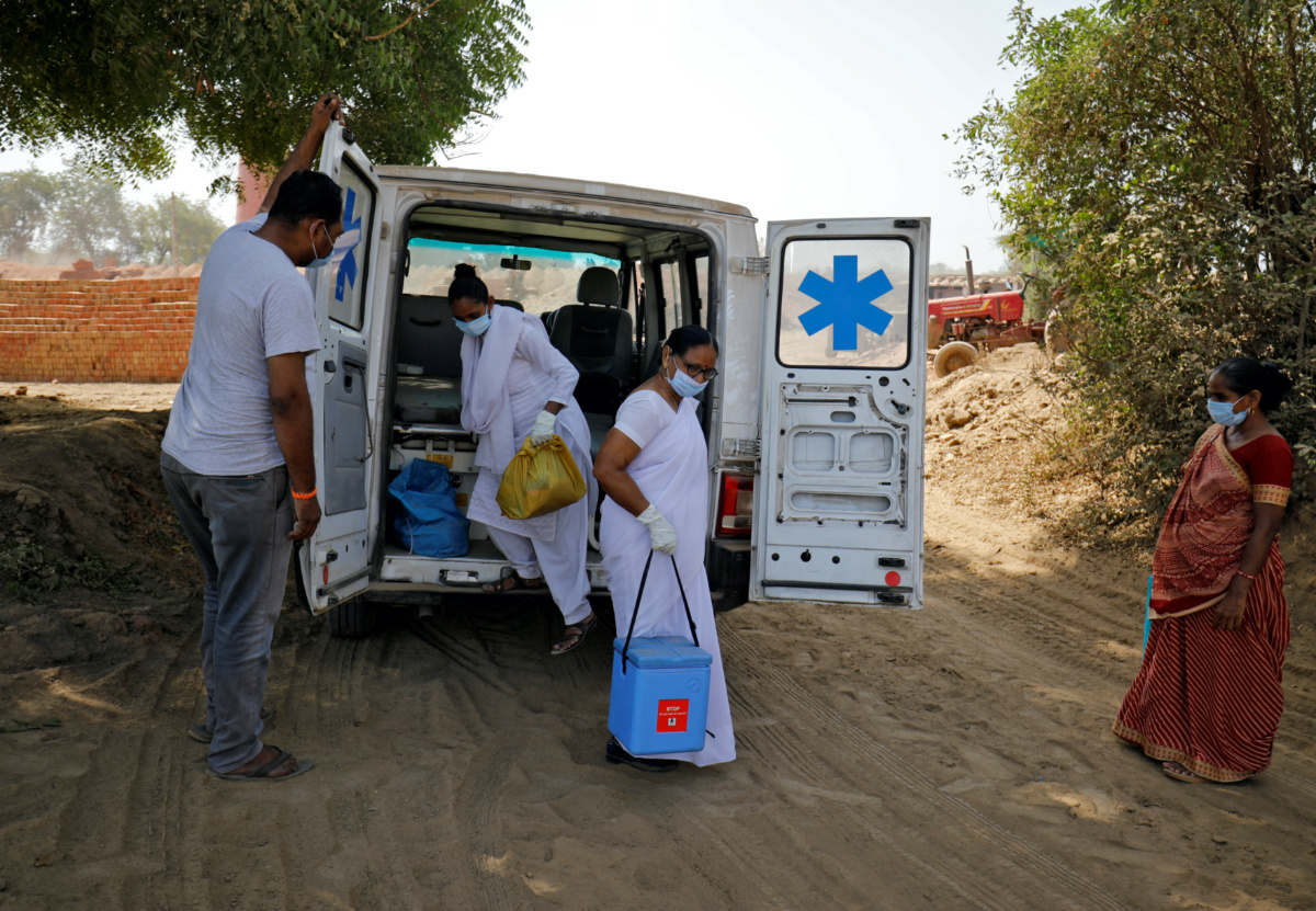 Healthcare workers arrive with doses of COVISHIELD, a coronavirus disease vaccine manufactured by Serum Institute of India, to be administered to workers of a brick kiln at Kavitha village on the outskirts of Ahmedabad, India, on 8th April, 2021.