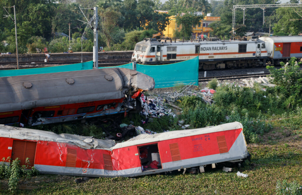 A train moves past damaged coaches, after the tracks were restored, at the site of a train collision following the accident in Balasore district in the eastern state of Odisha, India, on 5th June, 2023.