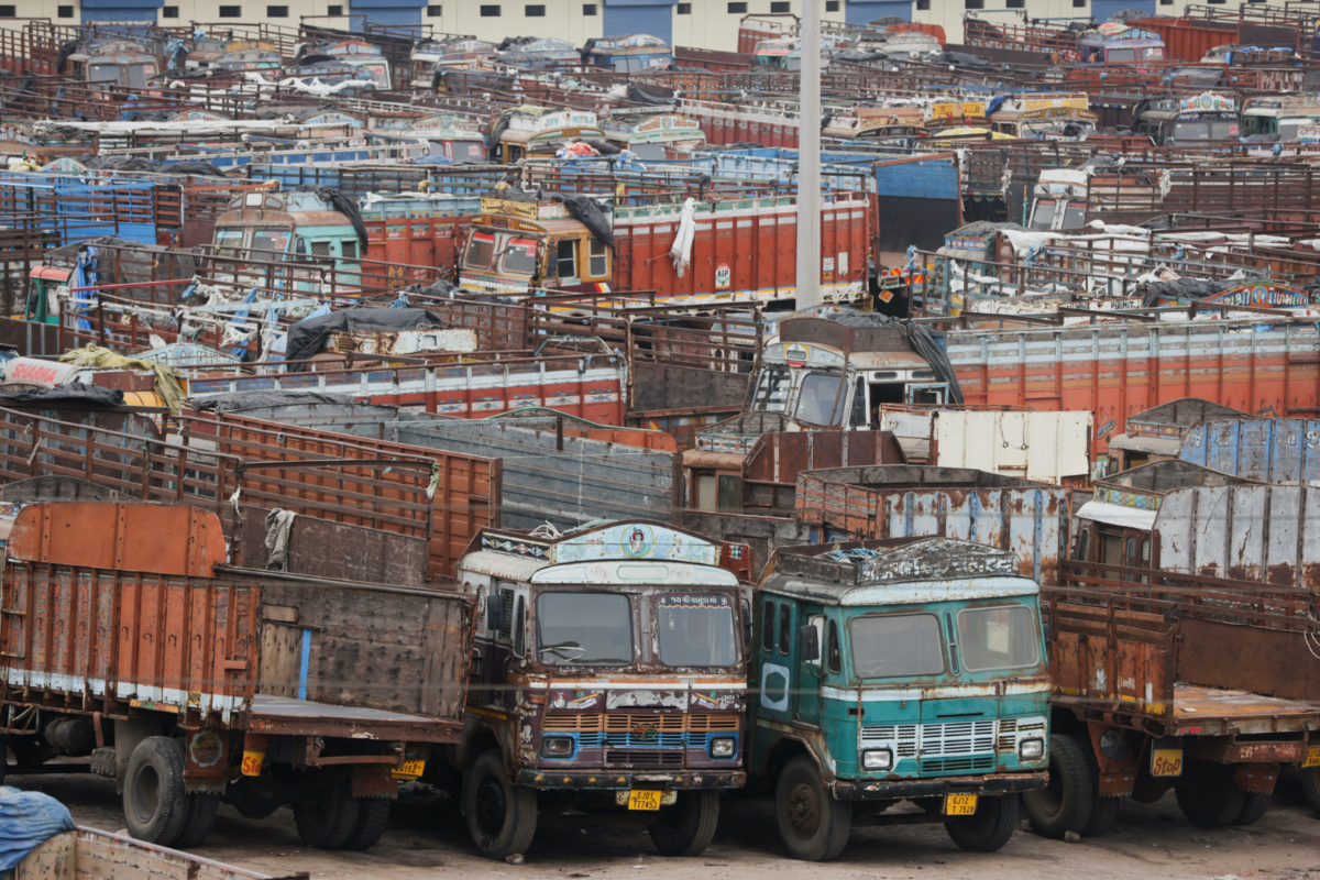 Trucks are parked at a terminal after all transportation was suspended before the arrival of cyclone Biparjoy, in Gandhidham, in the western state of Gujarat, India, on 13th June, 2023.