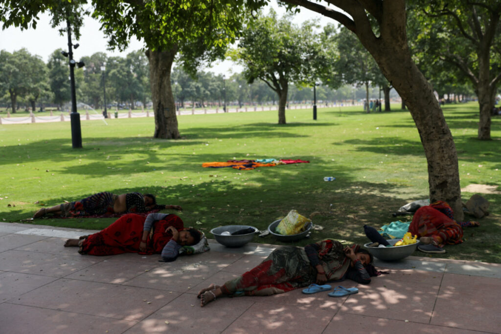 Women labourers rest under a tree on a hot summer day near India Gate, in New Delhi, India, on 15th May, 2023.