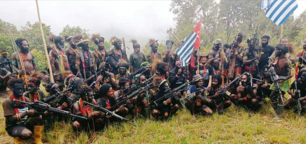 A man who is identified as Philip Mehrtens, the New Zealand pilot who is said to be held hostage by a pro-independence group, sits among separatist fighters in Indonesia's Papua region in this undated handout picture released on 26th May, 2023.