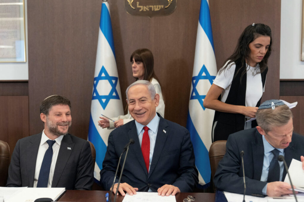 Israeli Prime Minister Benjamin Netanyahu, centre, and Finance Minister Bezalel Smotrich, left, attend a weekly cabinet meeting in the prime minister's office in Jerusalem, on 18th June, 2023.