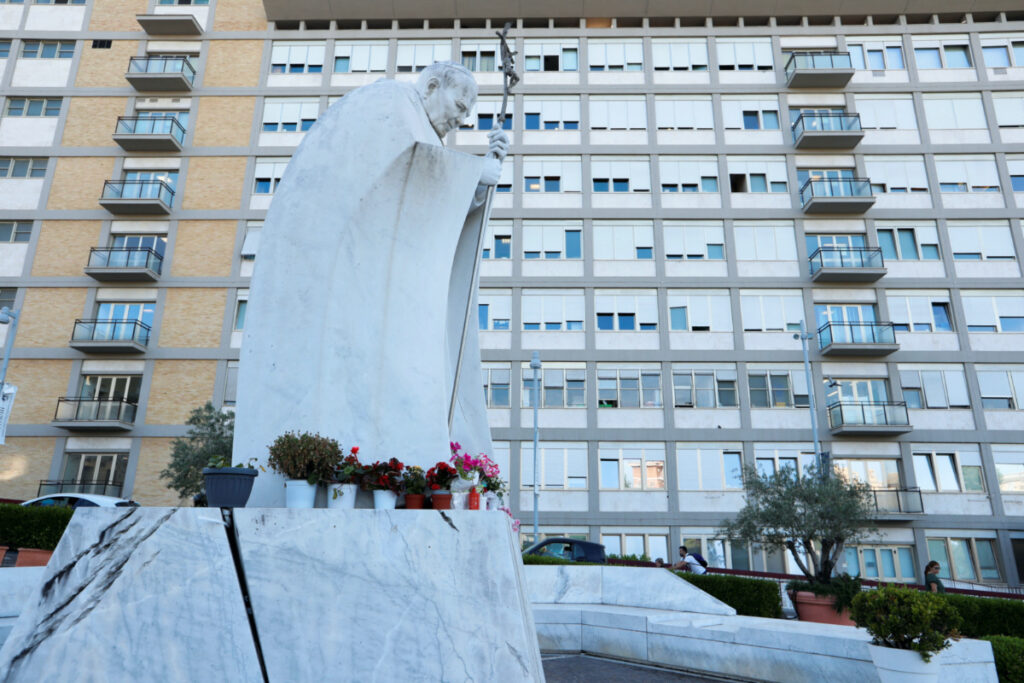 Flowers are seen at the statue of Pope John Paul II at Gemelli Hospital where Pope Francis is hospitalised for surgery on his abdomen, in Rome, Italy, on 9th June, 2023.