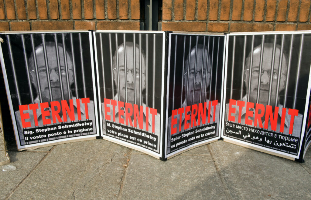 Posters reading "Stephan Schmidheiny your place is in prison" are displayed outside the courthouse during a trial against the Swiss firm Eternit's Italian plant in Turin, on 13th February, 2012.