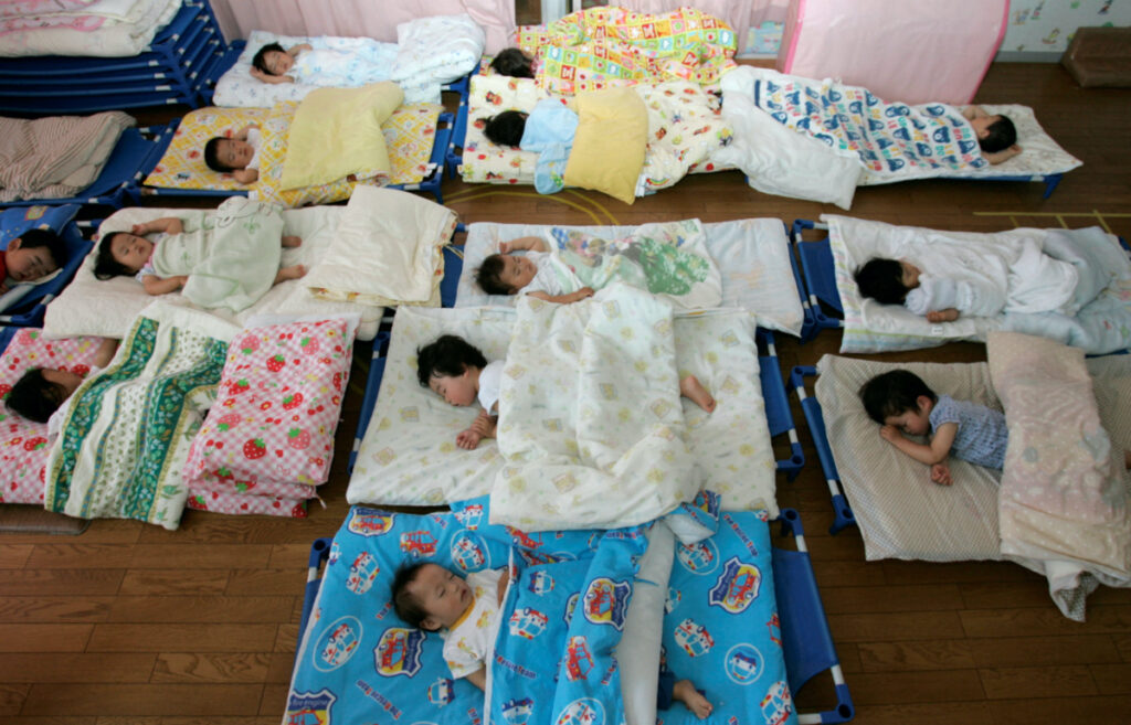 Nursery school children take a nap at Hinagiku nursery in Moriyama, western Japan, on 27th May, 2008