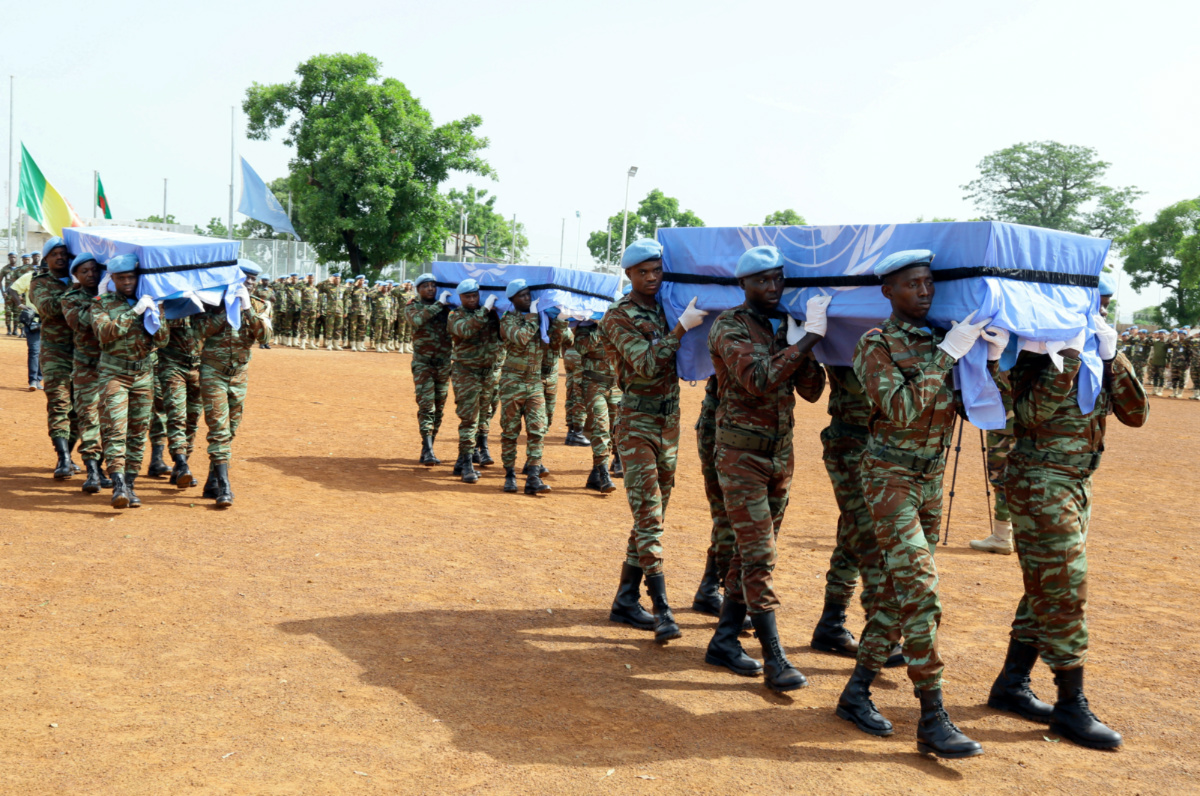 UN peacekeepers carry the coffins of the three United Nations soldiers from Bangladesh, who were killed by an explosive device in northern Mali on Sunday, during a ceremony at the MINUSMA base in Bamako, Mali, on 27th September, 2017.