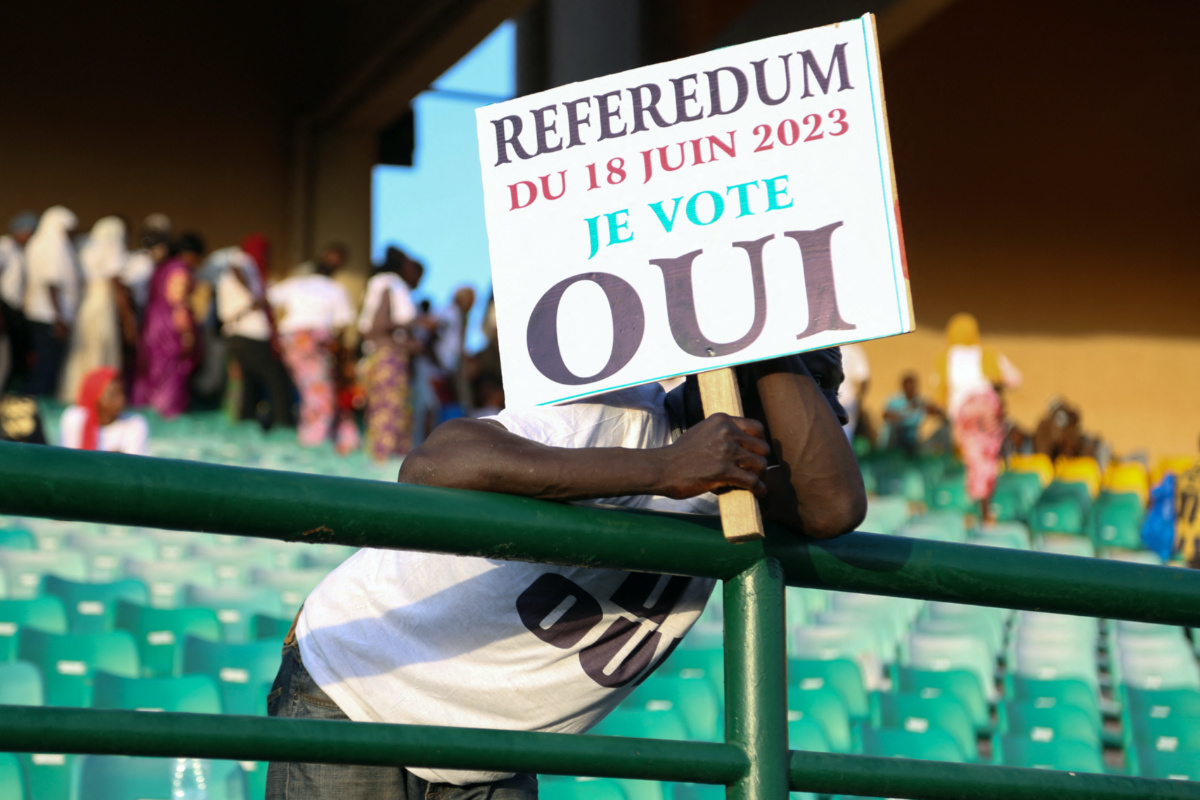 A man hold a sign as he attends the last campaign rally of the "Yes" group for the referendum on constitutional amendments that would return the country to constitutional rule, in Bamako, Mali, on 16th June, 2023. 