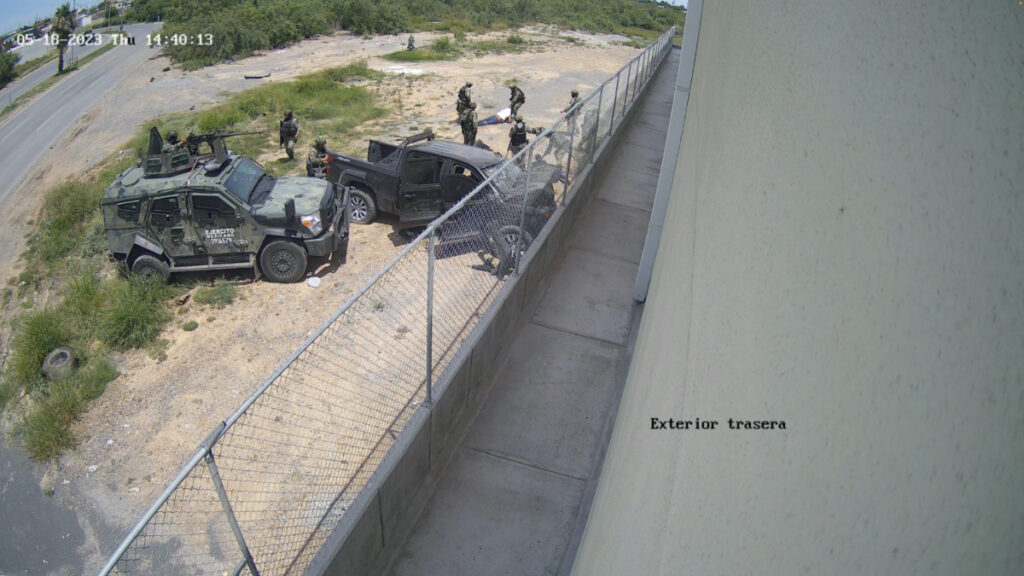 Soldiers drag a person whom they pulled out from a pick-up truck after it crashed into a wall at high speed in Nuevo Laredo, Tamaulipas, Mexico, on 18th May, 2023, in this screen grab obtained from a handout video.