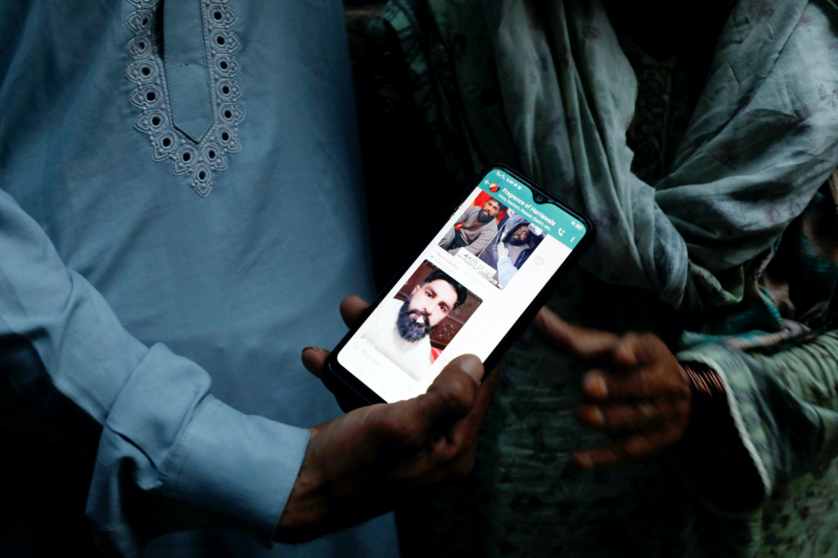 A family member shows a mobile phone with a picture of Muhammad Nadeem, 38, father of three sons, who along with others died when a migrant boat shipwrecked off the coast near Benghazi in Libya, outside his family home in Hariyawala town in Gujrat district of Punjab province, Pakistan, on 3rd March, 2023.