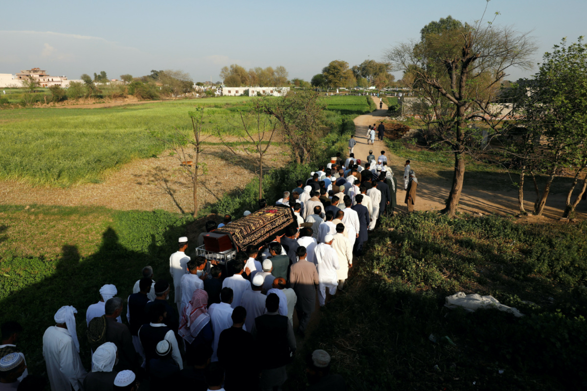 People carry the coffin of Muhammad Ali, 21, who along with others died when a migrant boat shipwrecked off the coast near Benghazi in Libya, during his funeral at a graveyard in Bhojpur town in Gujrat district of Punjab province, Pakistan, on 7th March 2023