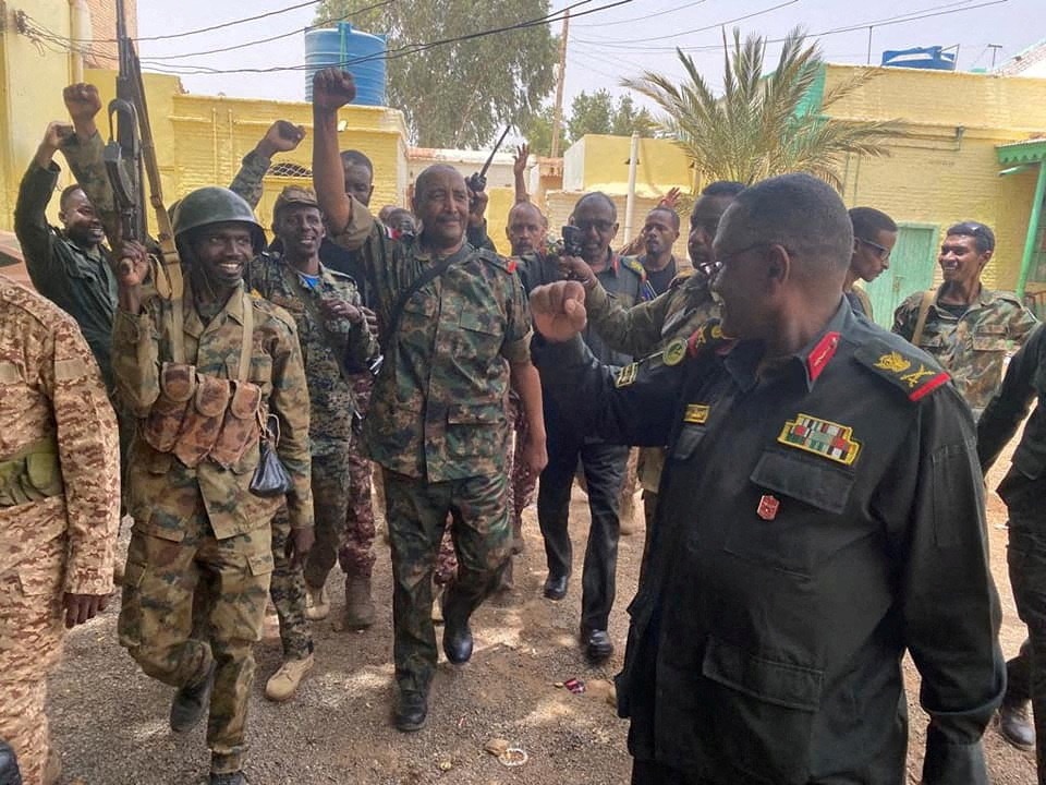 Sudan's General Abdel Fattah al-Burhan walks with troops,in an unknown location, in this picture released on 30th May, 2023.