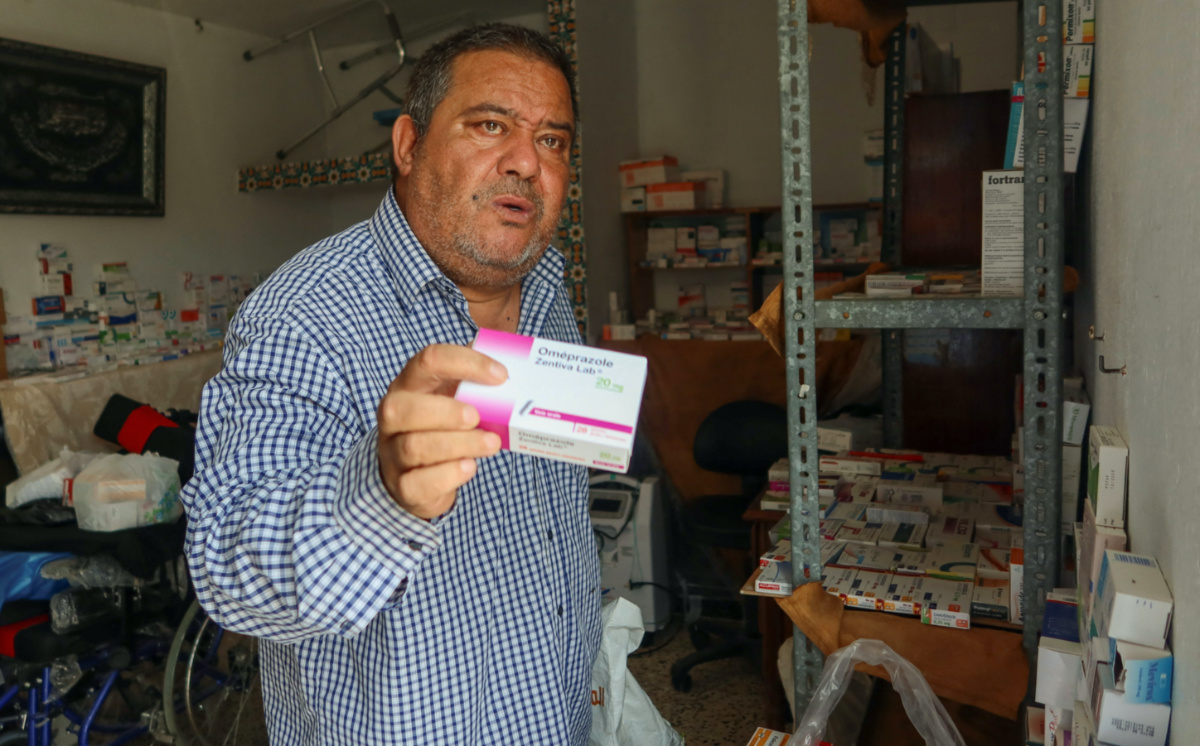 Retired soldier Nabil Boukhili, who has opened an unofficial medicine exchange for his neighbourhood from the roof of his Tunis house, holds a box of medicine in Tunis, Tunisia, on 29th May, 2023. 