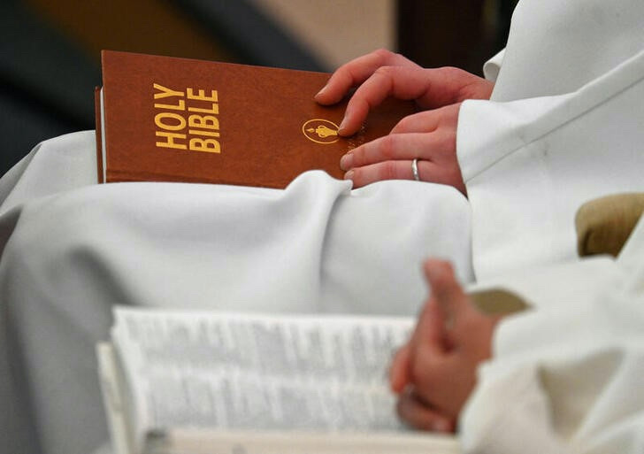 Delegates sit with copies of the Bible whilst attending the Church of England General Synod meeting in London, Britain, on 9th February, 2023.