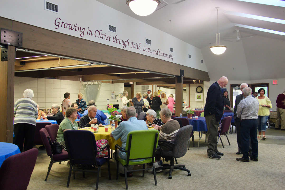 People celebrate two members' 60th wedding anniversary in the fellowship hall, Sunday, 11th June, 2023, after a service at Christ United Methodist Church in Greenfield, Wisconsin.