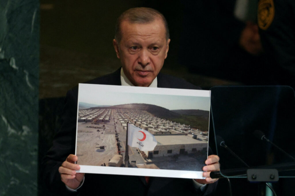 Turkey's President Tayyip Erdogan holds up a photo of what he described as a Syrian refugee camp in Turkey as he addresses the 77th Session of the United Nations General Assembly at UN Headquarters in New York City, US, on 20th September, 2022.