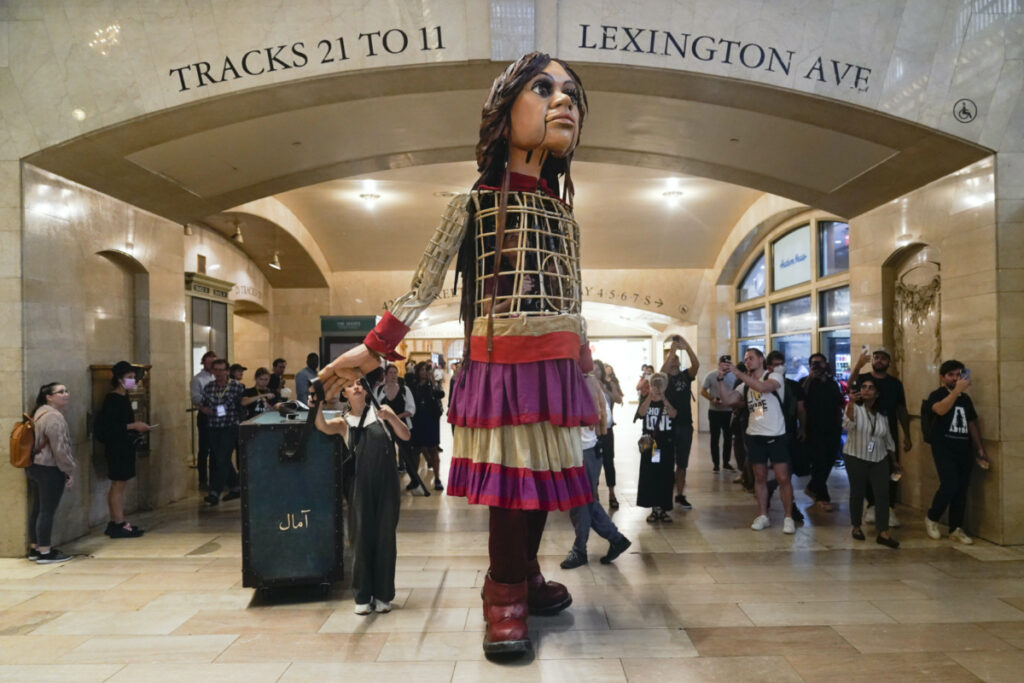 A 3.7 metre puppet of a 10-year-old Syrian refuge named Little Amal walks around Grand Central Station in New York, on 15th September, 2022.
