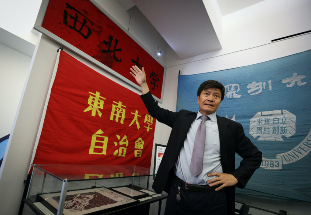 Zhou Fengsuo, curator of the Tiananmen June 4th Memorial permanent exhibition, speaks in front of The “Bloody Banner” of the Northwestern University in Xian, used to bind bullet wounds of a student near Tiananmen Square China during the uprising on 4th June, 1989, during a press preview of the museum which opens on 2nd June in Manhattan, in New York City, US