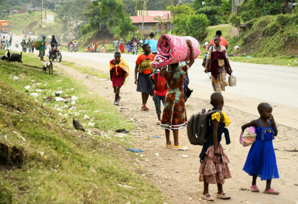 Residents flee from Bwera after militants linked to rebel group Allied Democratic Forces killed and abducted multiple people at the Mpondwe Lhubirira Secondary School, in Mpondwe, western Uganda, on 17th June, 2023.