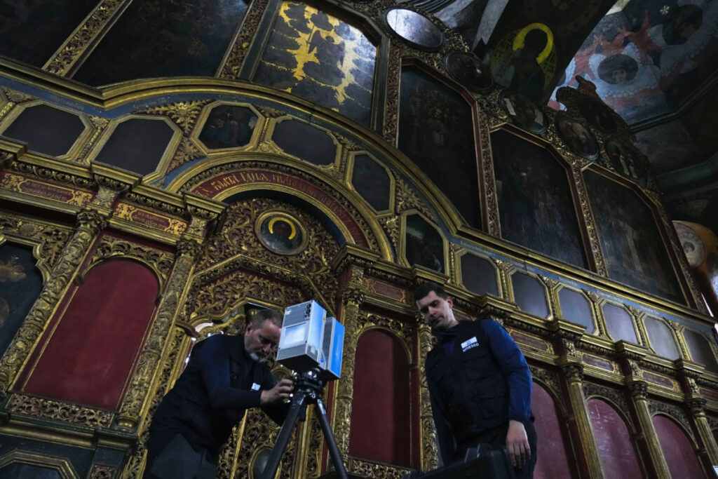 Volunteers Emmanuel Durand, left, and Serhii Revenko set up a high-tech scanner at the All Saints Church at the Kyiv-Pechersk Lavra in Kyiv, Ukraine, on Sunday, 11th June, 2023.