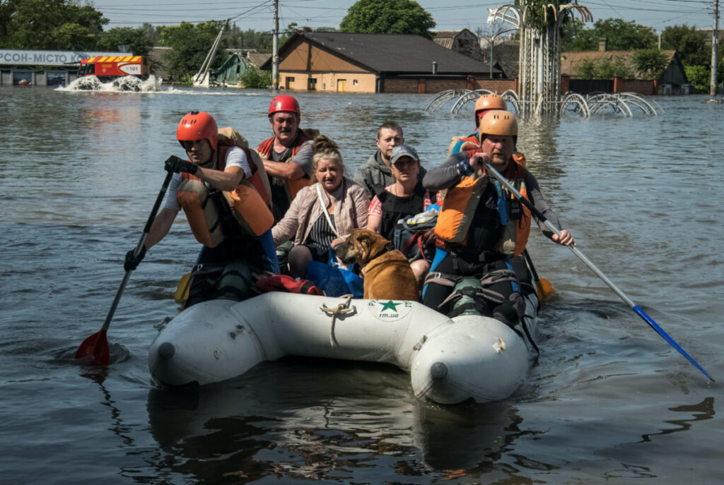 Rescuers evacuate local residents from a flooded area after the Nova Kakhovka dam breached, in Kherson, Ukraine, on 7th June, 2023.