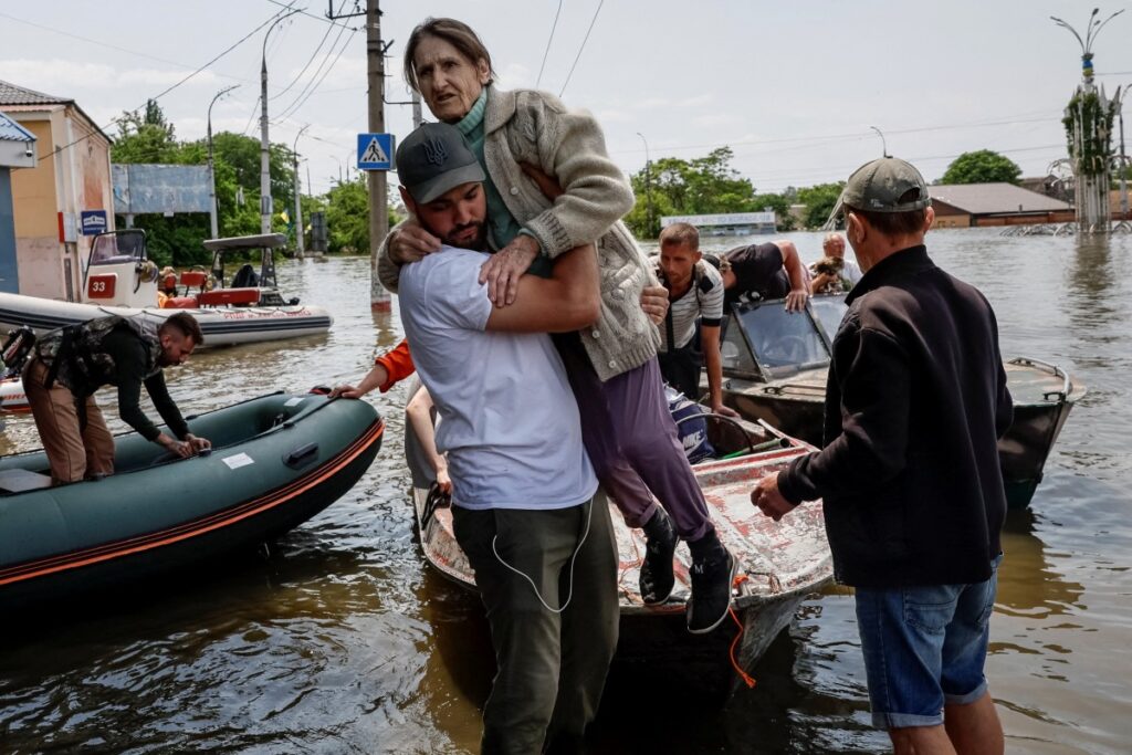 Volunteers evacuate local residents from a flooded area after the Nova Kakhovka dam breached, amid Russia's attack on Ukraine, in Kherson, Ukraine, on 8th June, 2023.