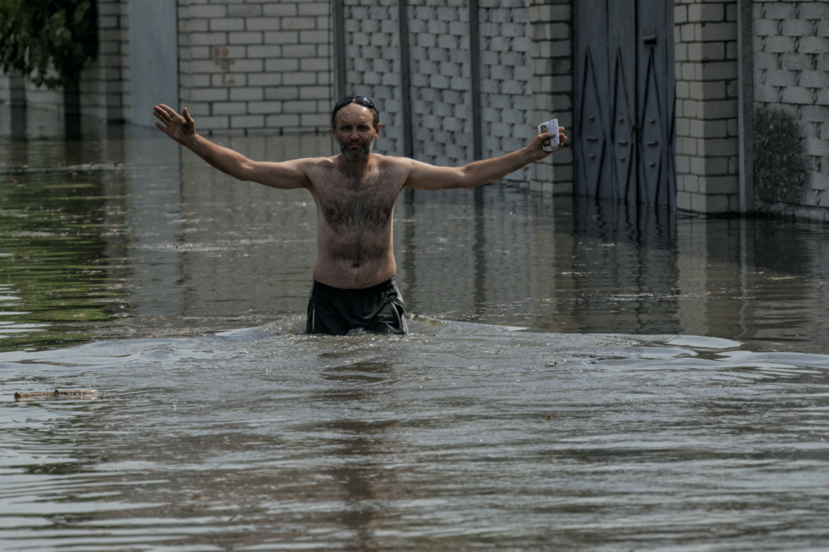 A local resident walks on a flooded street after the Nova Kakhovka dam breached, amid Russia's attack on Ukraine, in Kherson, Ukraine, on 6th June, 2023