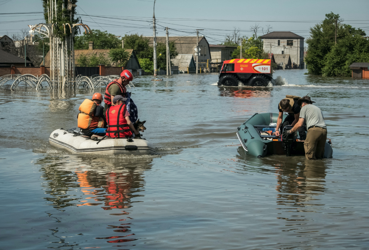 Rescuers evacuate local residents from a flooded area after the Nova Kakhovka dam breached, amid Russia's attack on Ukraine, in Kherson, Ukraine, on 7th June, 2023. 
