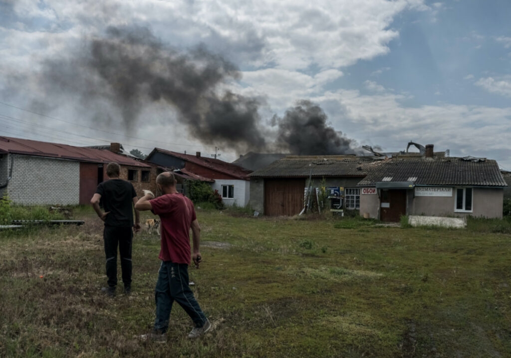 Local residents walk while smoke rises after shelling, amid Russia's attack on Ukraine, near the Ukraine-Russia border in the town of Vovchansk, in Kharkiv region, Ukraine, on 5th June, 2023.