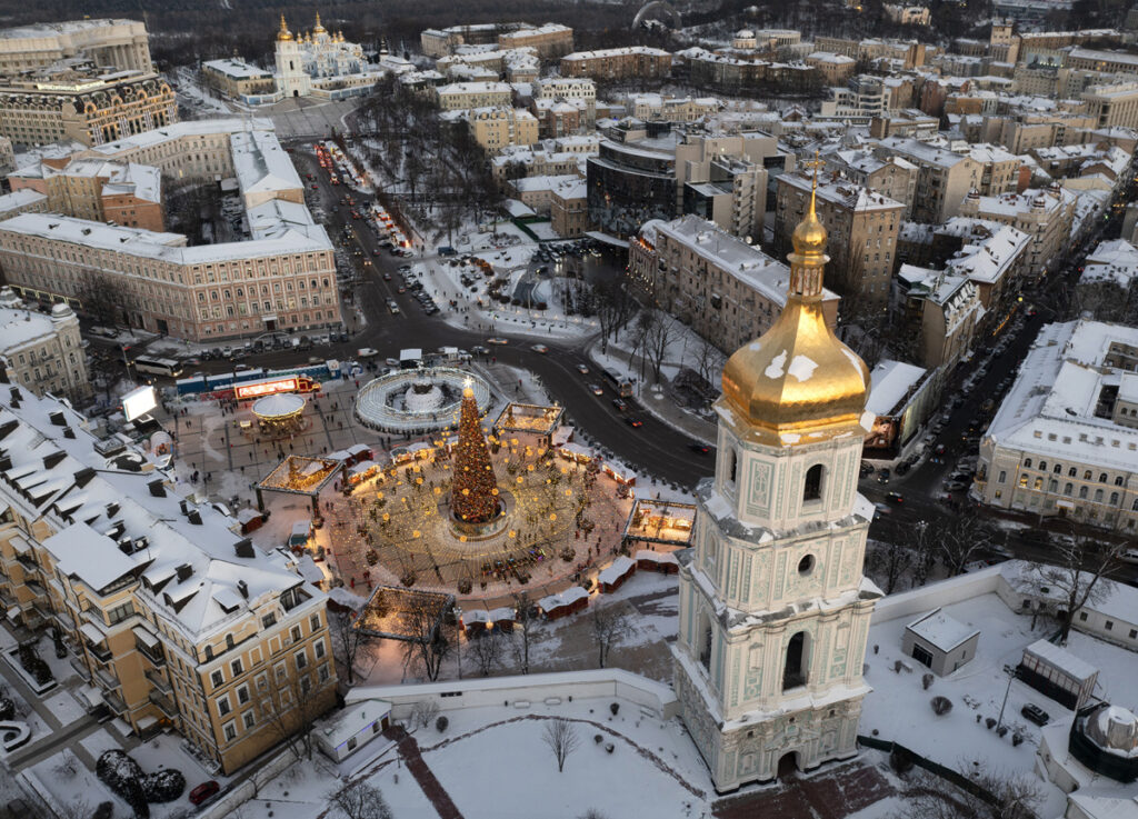 Snow covers the city center with a Christmas tree, St Sophia Cathedral, foreground, and St Michael Cathedral, background, in Kyiv, Ukraine, on Tuesday, 21st December, 2021.