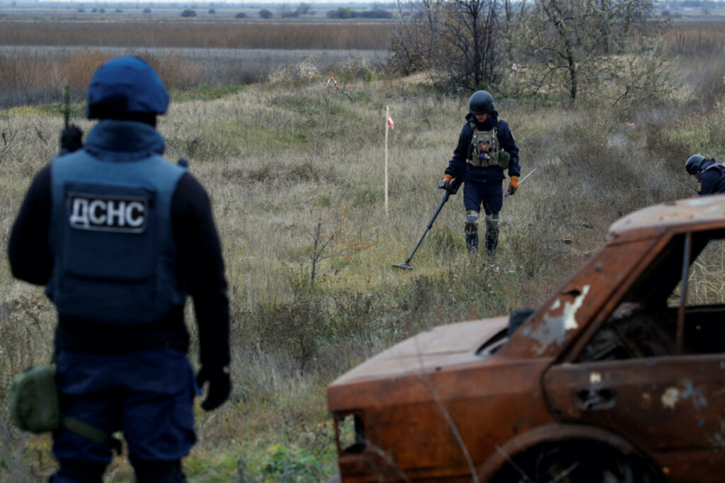 Ukrainian mine experts scan for unexploded ordnance and landmines by the main road to Kherson, Ukraine. on 16th November, 2022.
