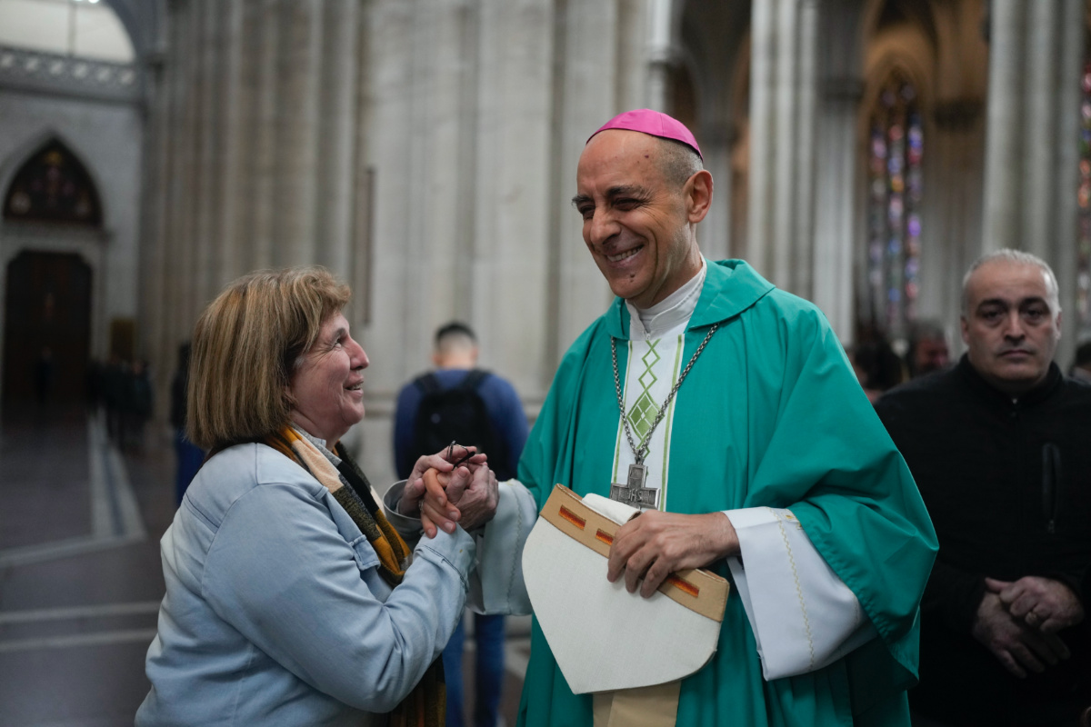 Monsignor Victor Manuel Fernandez, Archbishop of La Plata, holds hands with a woman after a Mass at the Cathedral in La Plata, Argentina, on Sunday, 9th July, 2023. 