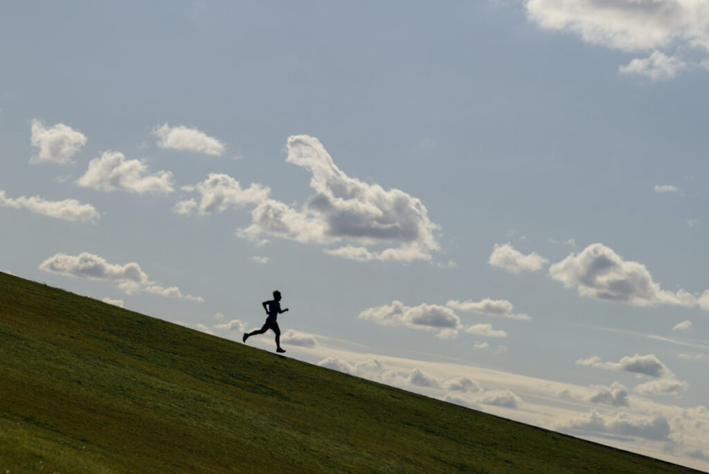 A runner exercises on a hill at Sydney Park in Sydney, Australia, on 26th June, 2020.