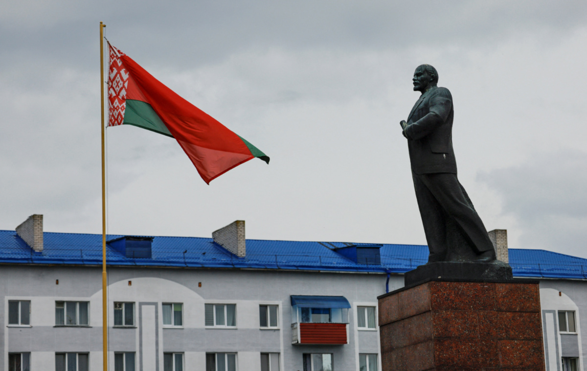 A Belarusian national flag flies in front of a monument to Soviet state founder Vladimir Lenin in the town of Asipovichy, Belarus, on 7th July, 2023.