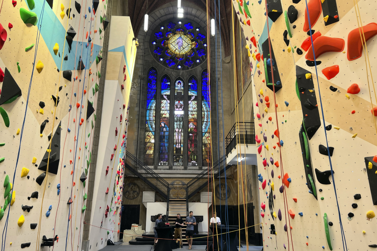 People stand in back of ropes for a climbing wall in the repurposed Saint-Antoine church in Brussels, Belgium, on Wednesday, 21st June, 2023